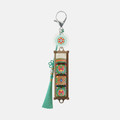 White dancheong keycap keychain with a green tassel