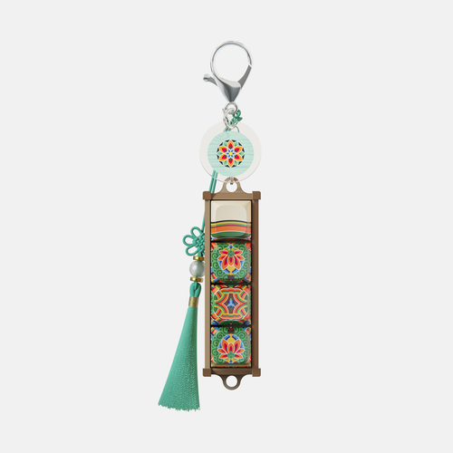 White dancheong keycap keychain with a green tassel
