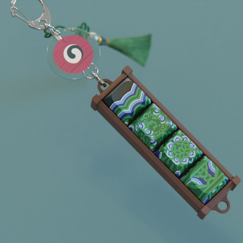 Sungnyemun Dancheong keycap keychain and round charm on a dark green surface