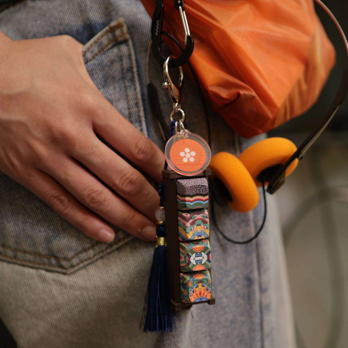Hand holding a Gyotaejeon Dancheong keycap keychain
