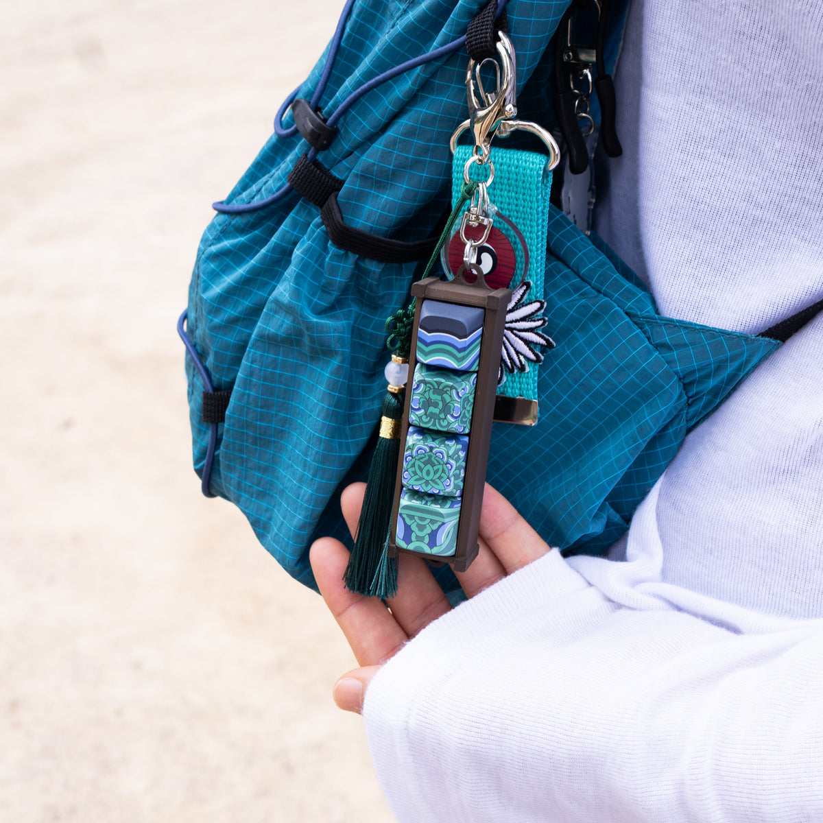 Hand holding a Sungnyemun Dancheong keycap keychain
