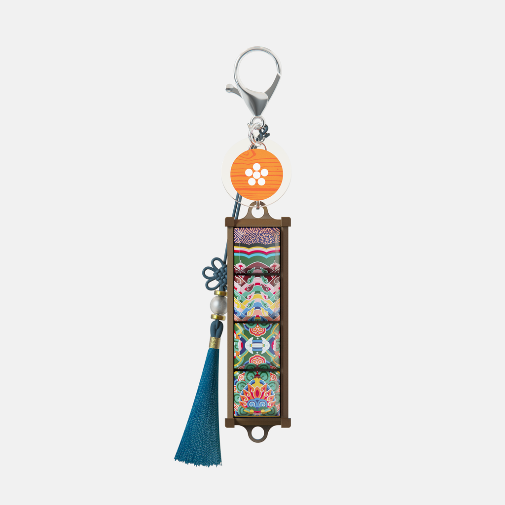 Gyotaejeon Dancheong keycap keychain with a blue tassel
