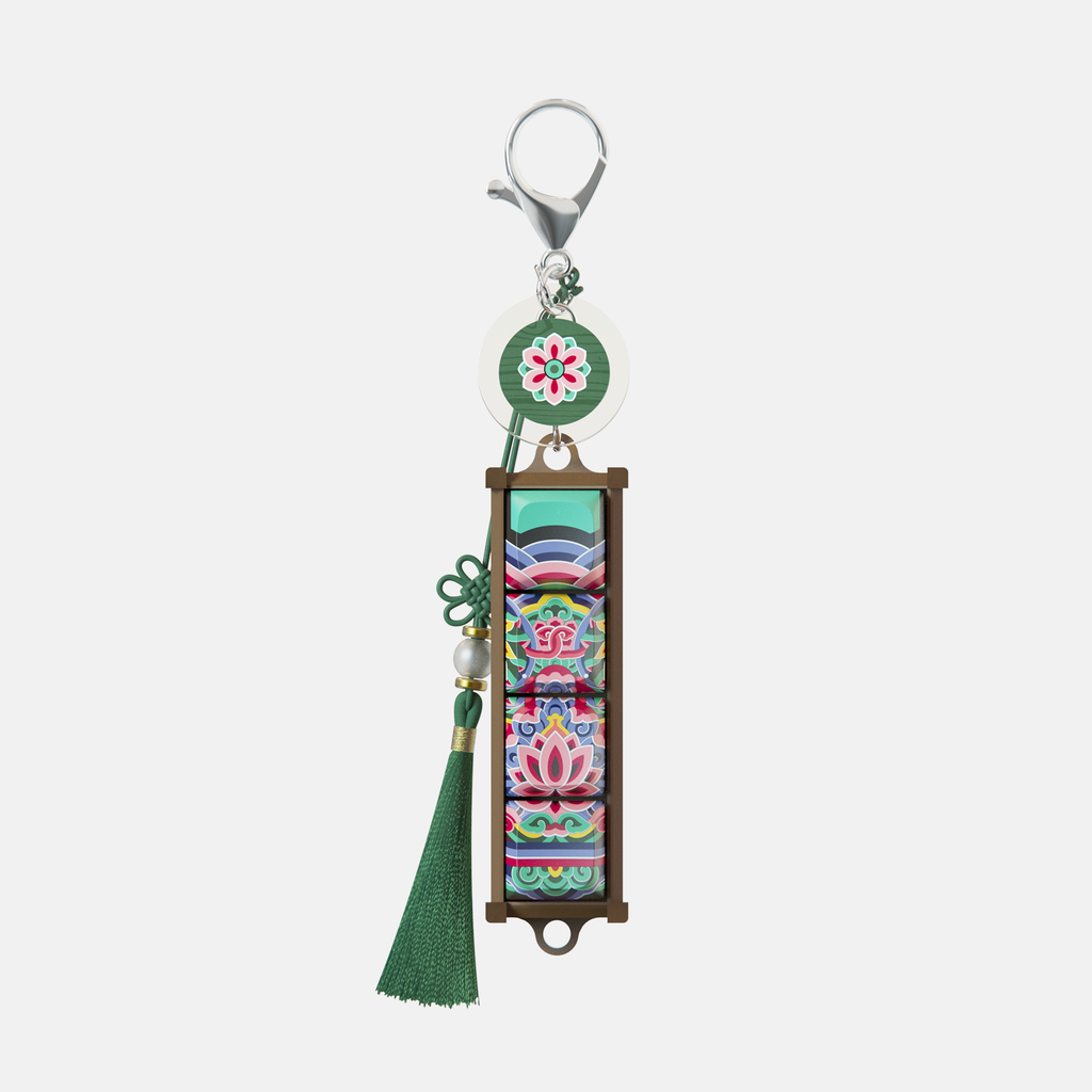 Black Dancheong keycap keychain with a green tassel