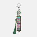 Black Dancheong keycap keychain with a green tassel